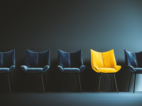 Hiring concept design. One empty yellow chair among many. One spot left.